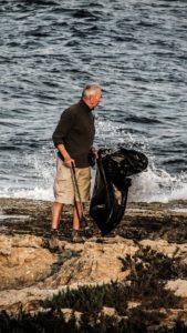 man-volunteering-on-vacation-to-pick-up-trash-sundance-vacations