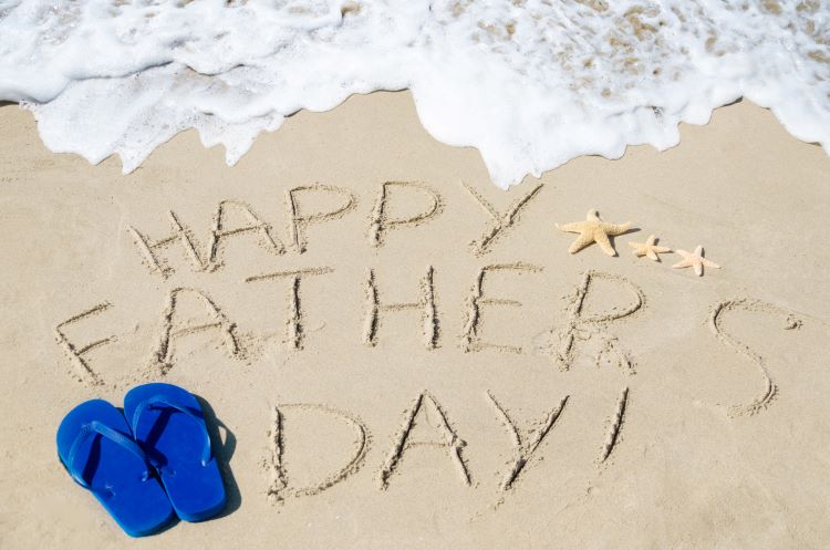 Happy Father's Day written in sand