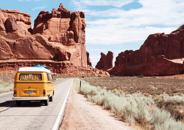 Van driving on road through mountains