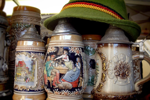 Close-up of German beer steins and Alpine hat