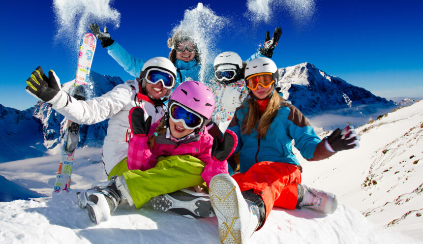 Family playing with snow on ski